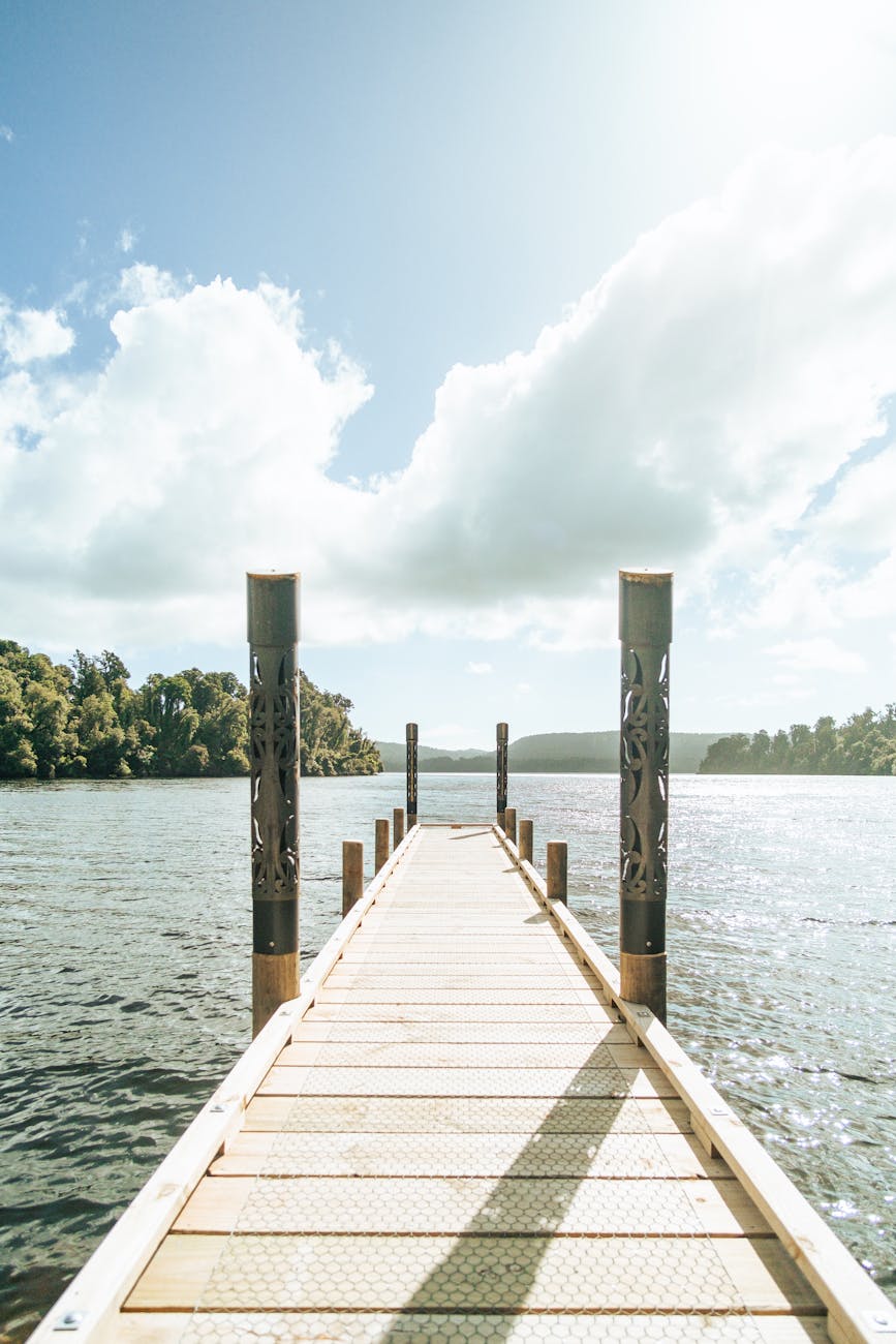 a wooden dock with a pier and a lake